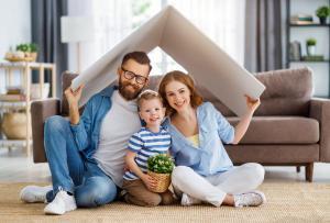 A young Irish couple with their child in their living room covered by mortgage protection.